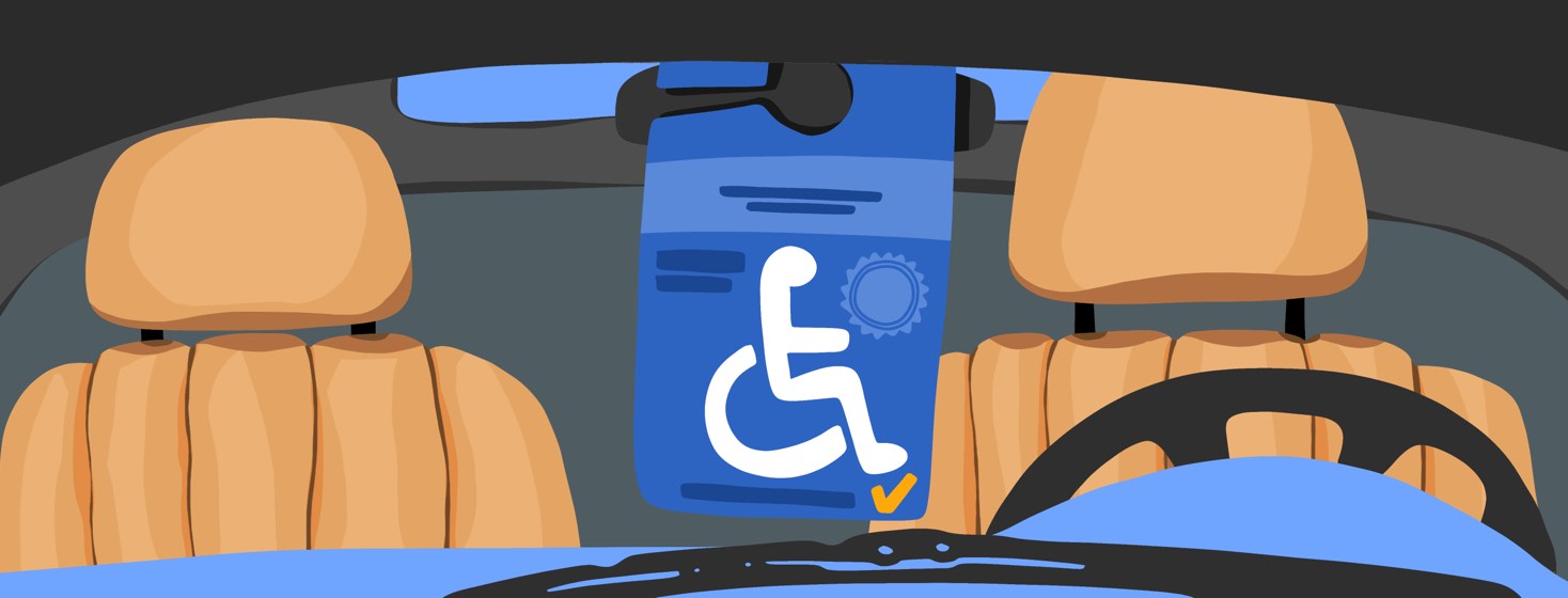 A handicap placard hanging from the rearview mirror in a car.