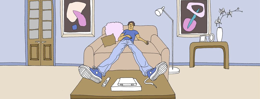 A fatigued man is perched on a couch with his feet up on a coffee table.